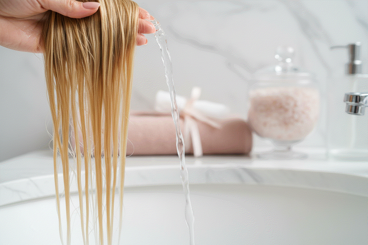 Woman gently washing halo hair extensions with sulfate-free shampoo and conditioner
