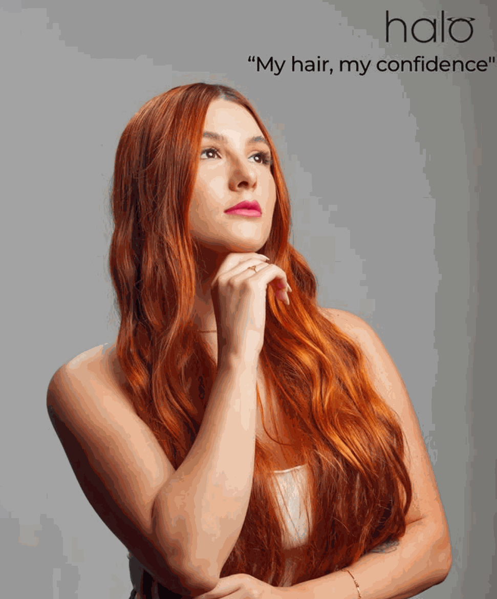 woman with long autumn hair wearing halo hair extension outdoors with fall foliage background