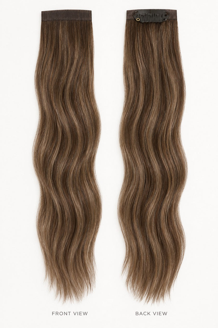 Bang Booster clip-in hair extensions in mixed brown and blonde, with long wavy strands and discreet mini clips.