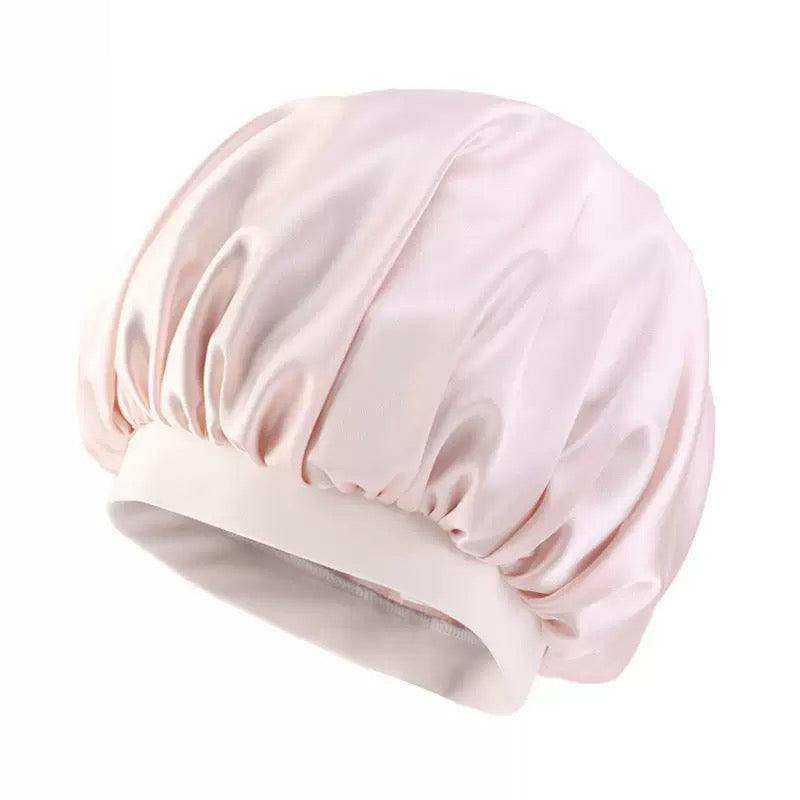 Cream Bonnet Cap in pale blush satin with a gathered, smooth crown and wide cream elastic band